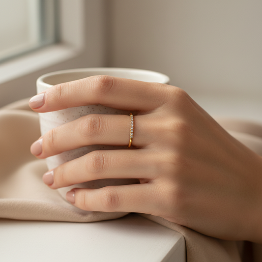 Dainty gold-plated pave CZ ring worn on elegant fingers