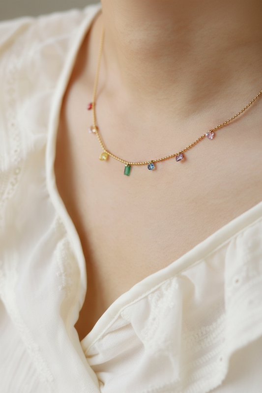 Lifestyle editorial photo of rainbow gemstone charm necklace on model