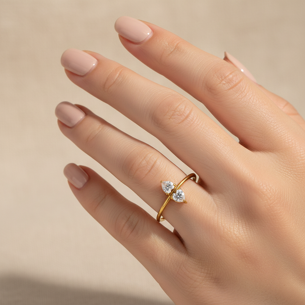 Lifestyle photo of dual stone bypass gold ring worn on hand